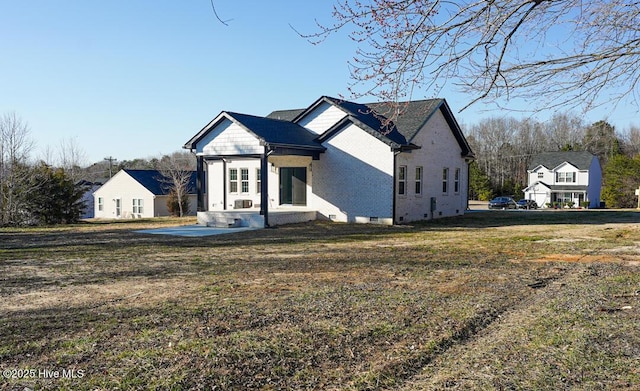 view of front of property with brick siding and a front lawn