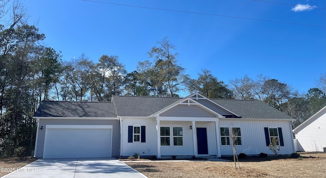 view of front facade featuring a garage, concrete driveway, and a shingled roof