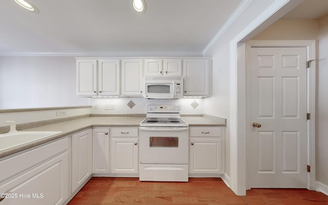 kitchen with light wood-type flooring, white appliances, white cabinetry, and crown molding