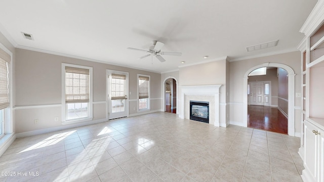 unfurnished living room featuring arched walkways, light tile patterned floors, and visible vents