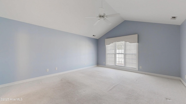 carpeted empty room with lofted ceiling, baseboards, visible vents, and ceiling fan