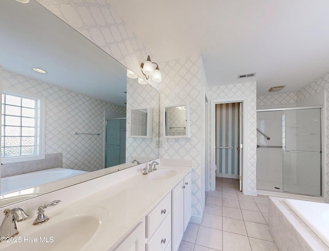 bathroom with a stall shower, a sink, visible vents, and wallpapered walls