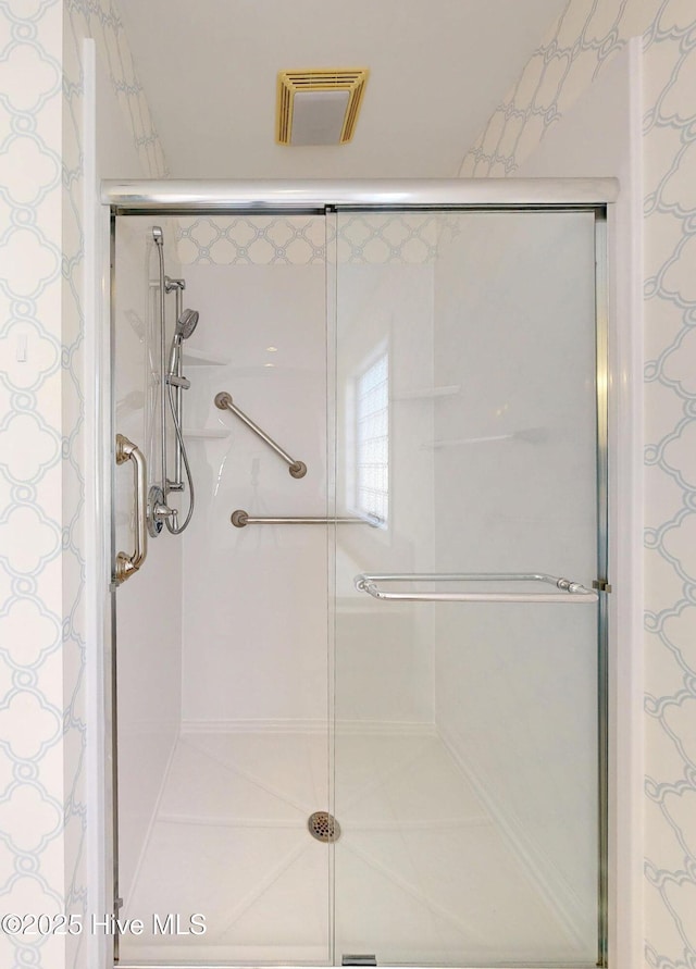 bathroom with visible vents and a shower stall