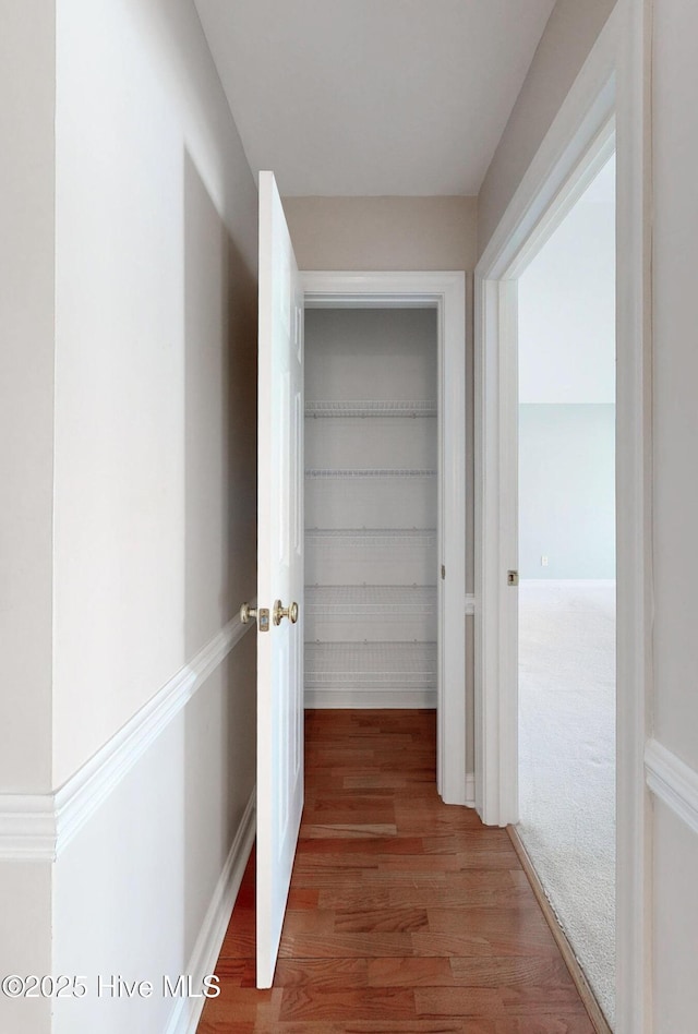 hall with wood finished floors