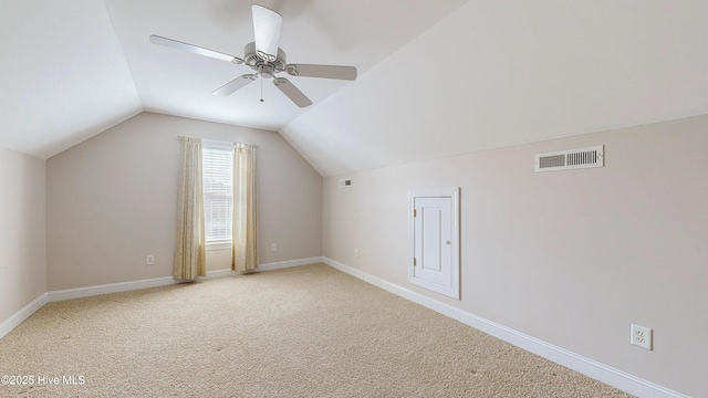 additional living space with lofted ceiling, visible vents, carpet flooring, ceiling fan, and baseboards