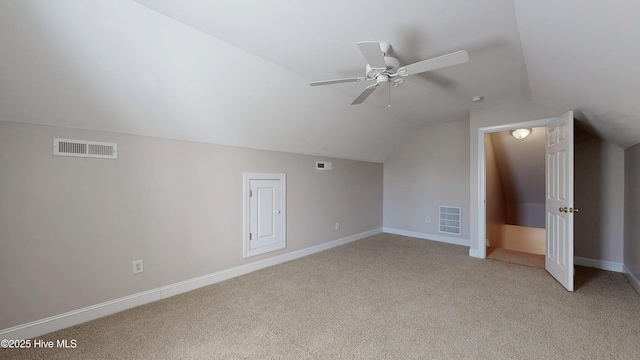 additional living space featuring light colored carpet, visible vents, and baseboards