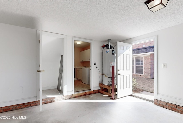 interior space featuring water heater and washer / clothes dryer