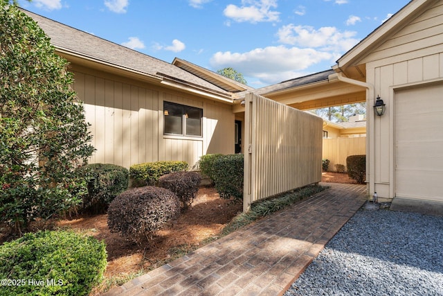 view of side of home with fence