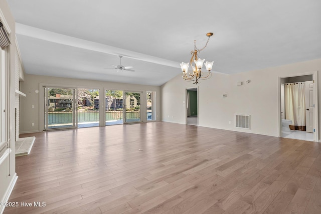 unfurnished living room with visible vents, vaulted ceiling, wood finished floors, and ceiling fan with notable chandelier