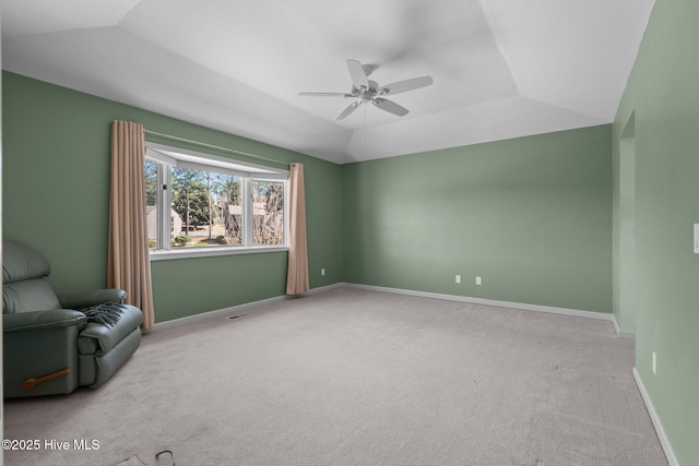 unfurnished room featuring carpet floors, lofted ceiling, baseboards, and a ceiling fan