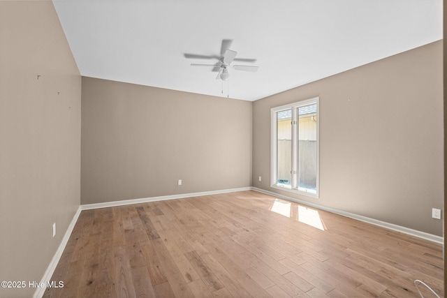 empty room with light wood-style floors, ceiling fan, and baseboards