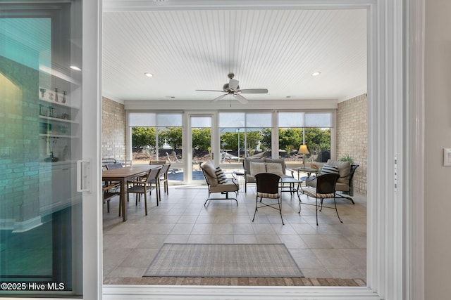 sunroom with a wealth of natural light and a ceiling fan