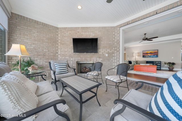 view of patio featuring an outdoor living space with a fireplace