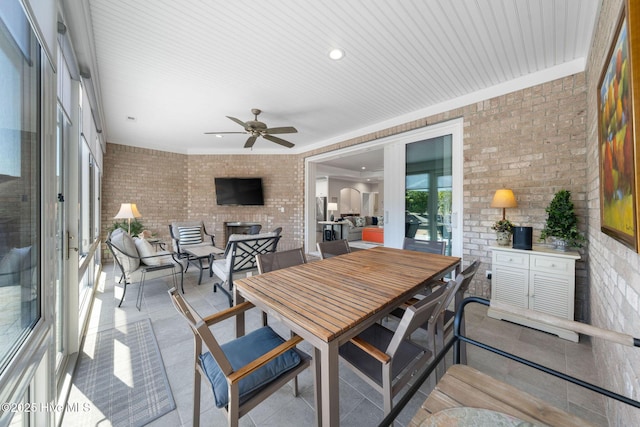 sunroom / solarium featuring french doors and a ceiling fan