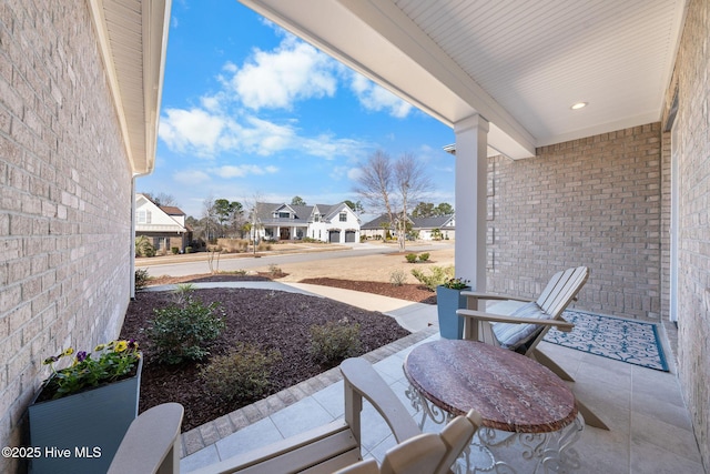 view of patio featuring a residential view and a porch