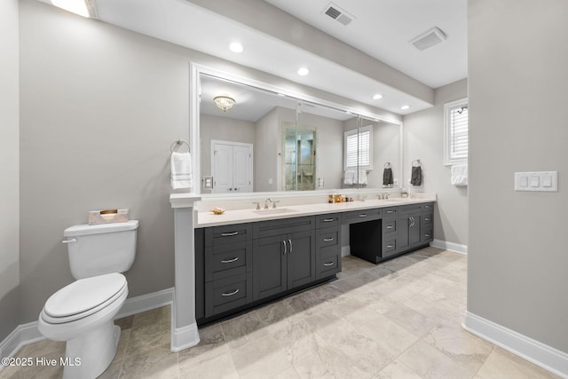 full bath featuring baseboards, visible vents, a sink, and toilet