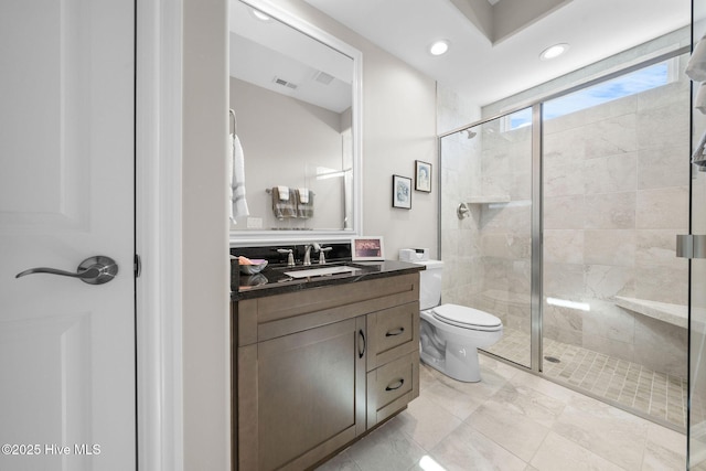 full bath with toilet, a shower stall, visible vents, and vanity