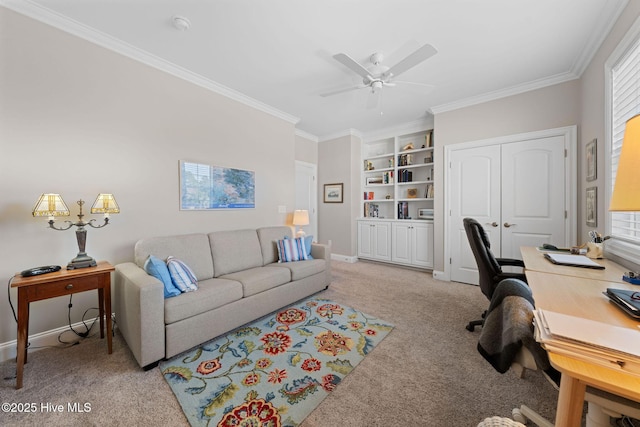 office area featuring ceiling fan, built in shelves, light colored carpet, baseboards, and ornamental molding