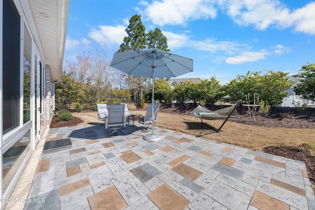 view of patio featuring outdoor dining space and fence