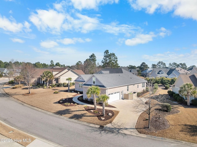 view of front of house featuring concrete driveway, an attached garage, and a residential view