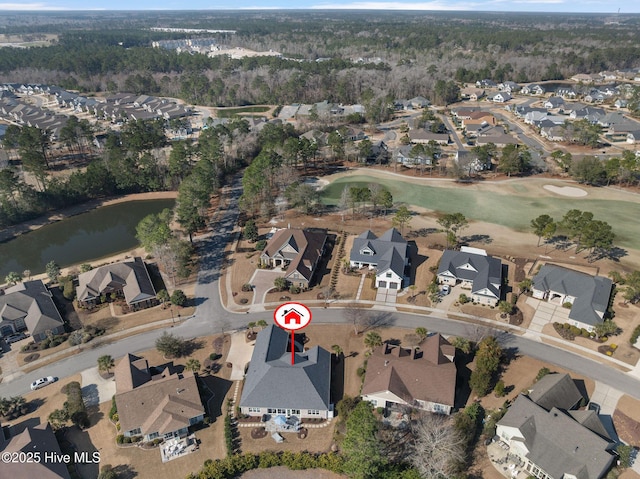 drone / aerial view with a residential view, view of golf course, and a water view