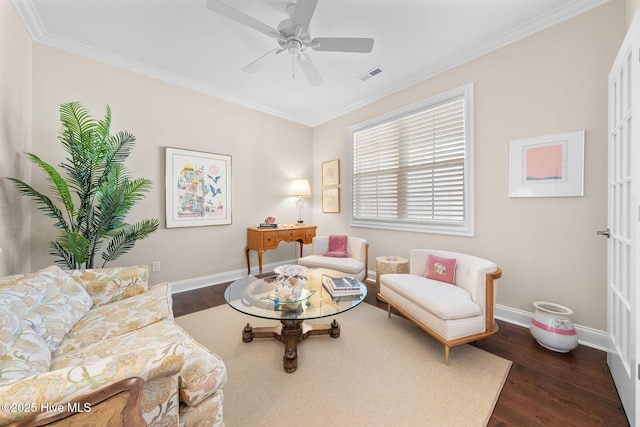 living area featuring ornamental molding, dark wood-style flooring, and baseboards