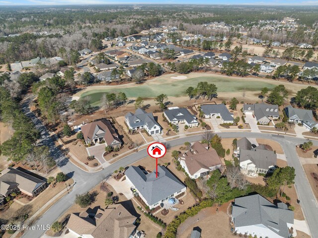 drone / aerial view with a residential view and golf course view