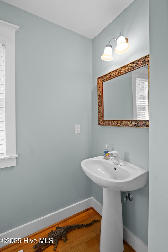 bathroom with baseboards and wood finished floors