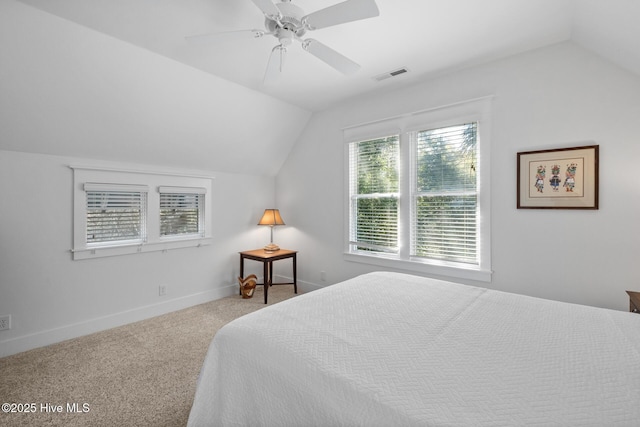 bedroom featuring lofted ceiling, a ceiling fan, visible vents, baseboards, and carpet