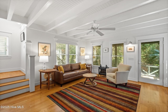 sunroom / solarium with beamed ceiling and a ceiling fan