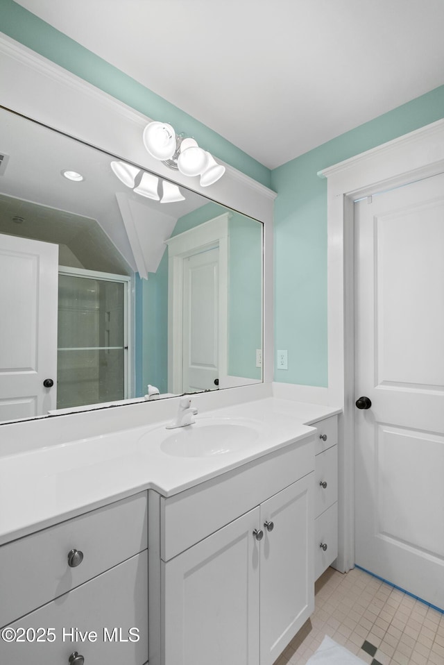 bathroom featuring lofted ceiling, vanity, and an enclosed shower