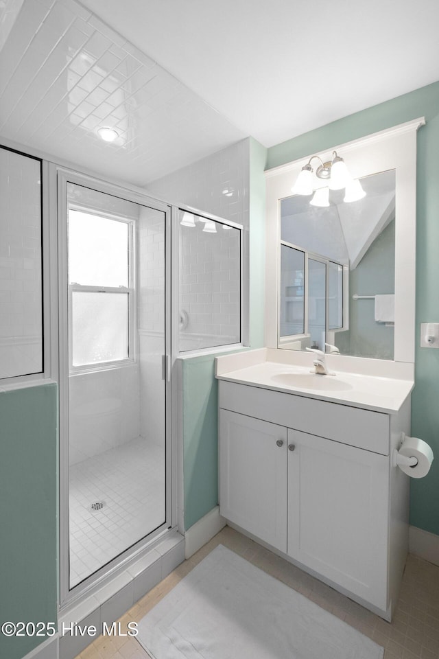 full bath with a shower stall and vanity