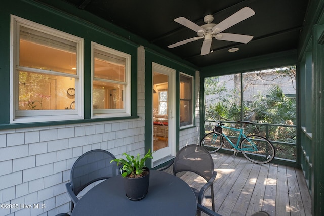 sunroom featuring ceiling fan