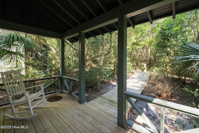 wooden deck with a view of trees