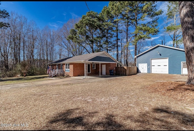 ranch-style house with brick siding, a porch, a garage, an outdoor structure, and driveway