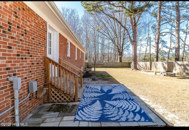 view of yard with entry steps and a fenced backyard