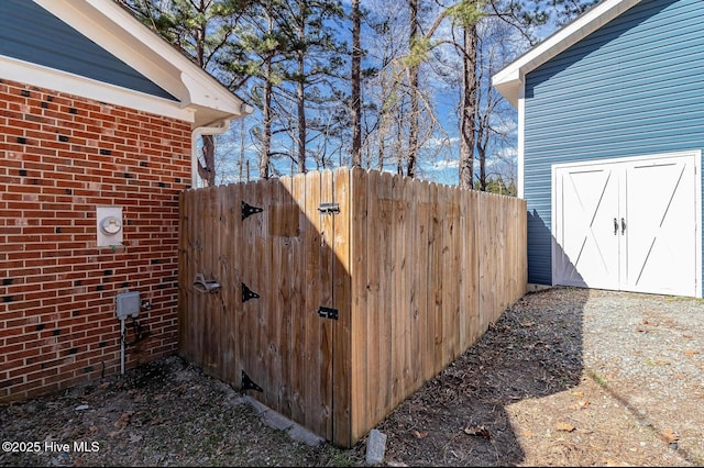 exterior space featuring brick siding and fence