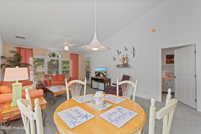 dining room with ceiling fan, high vaulted ceiling, carpet floors, visible vents, and baseboards