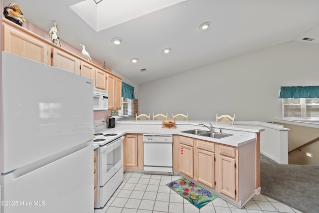 kitchen with light tile patterned flooring, a peninsula, white appliances, a sink, and light brown cabinetry