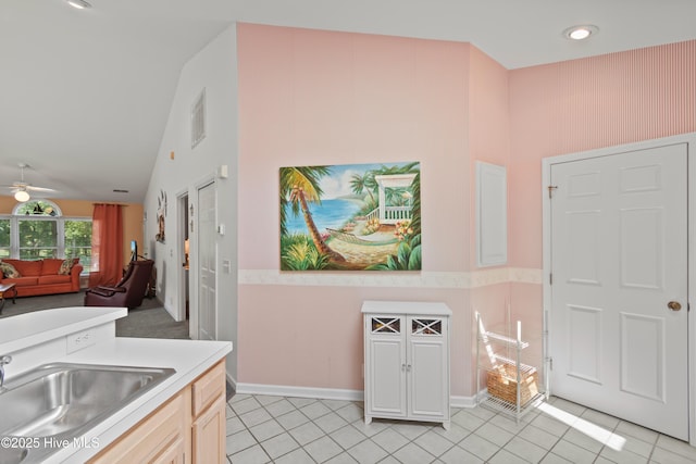 kitchen with light countertops, visible vents, a sink, and light tile patterned floors