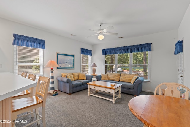 carpeted living room with ceiling fan, visible vents, and baseboards