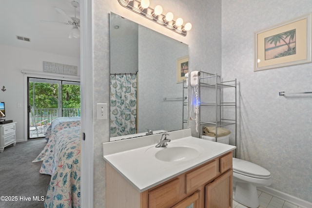 full bathroom with toilet, visible vents, vanity, baseboards, and ensuite bath