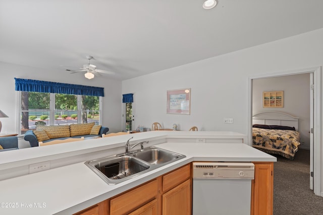 kitchen with open floor plan, white dishwasher, light countertops, carpet floors, and a sink