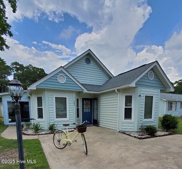 ranch-style home with roof with shingles