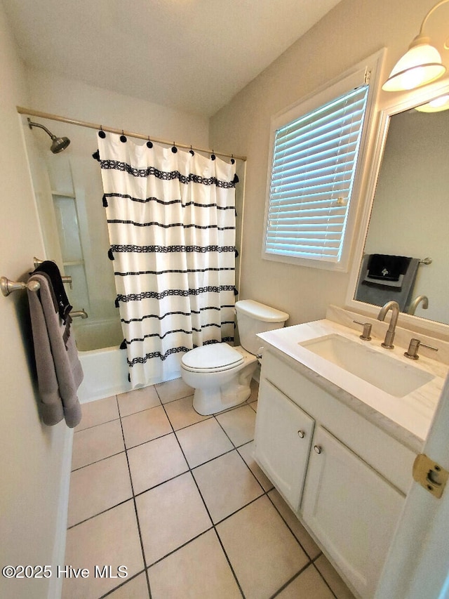 bathroom featuring toilet, shower / tub combo with curtain, vanity, and tile patterned flooring