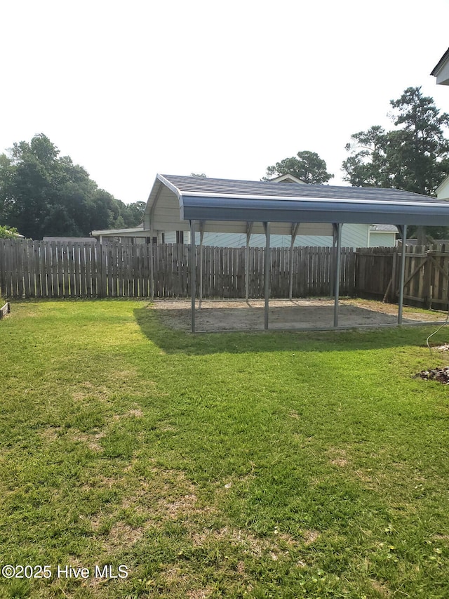 view of yard with a carport and fence