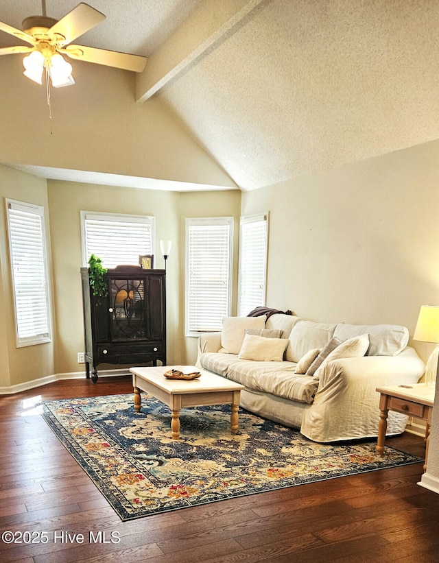 living area with vaulted ceiling with beams, baseboards, a textured ceiling, a ceiling fan, and wood-type flooring