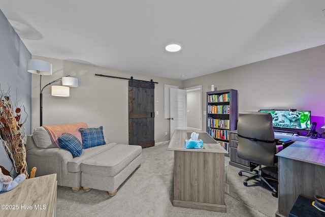 office space featuring a barn door, baseboards, and light colored carpet