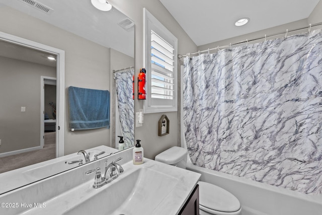 full bathroom featuring vanity, baseboards, visible vents, shower / bath combo with shower curtain, and toilet