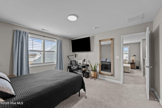 bedroom with visible vents, light colored carpet, and baseboards